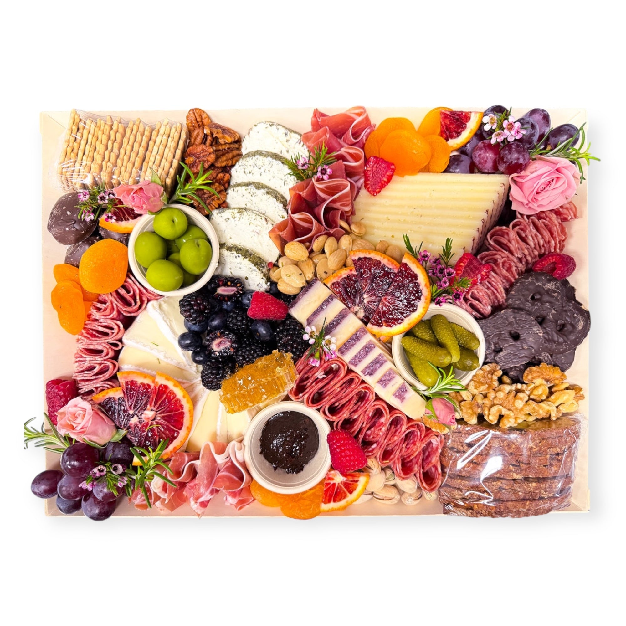 Original charcuterie platter with cheeses, cured meats, fruit, olives, nuts, crackers, and accompaniments styled by Newport Charcuterie.